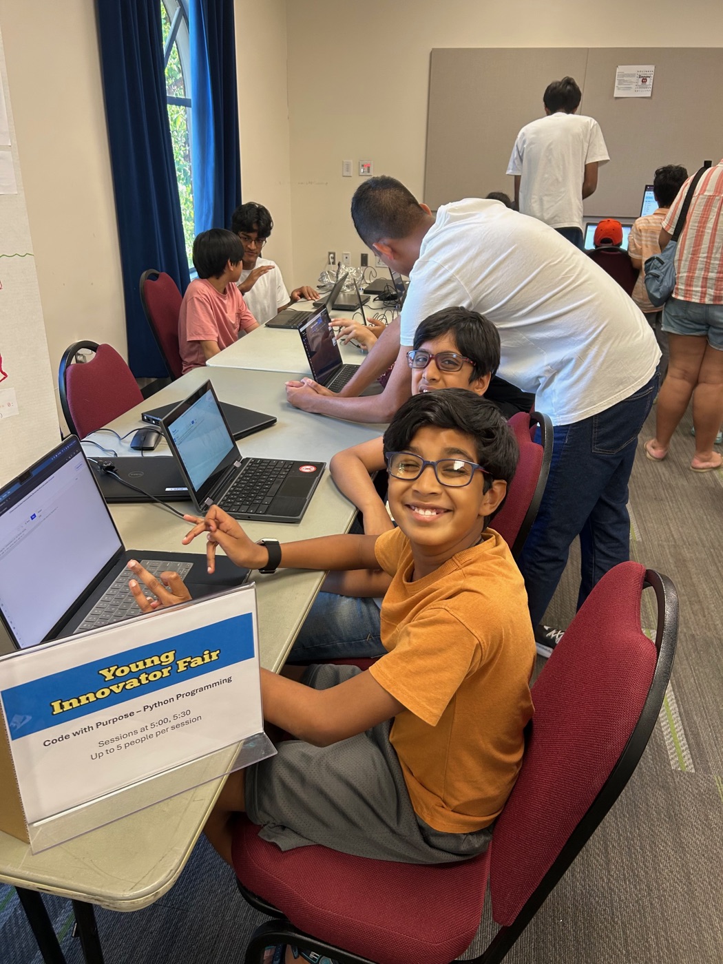 Student smiling while learning to code